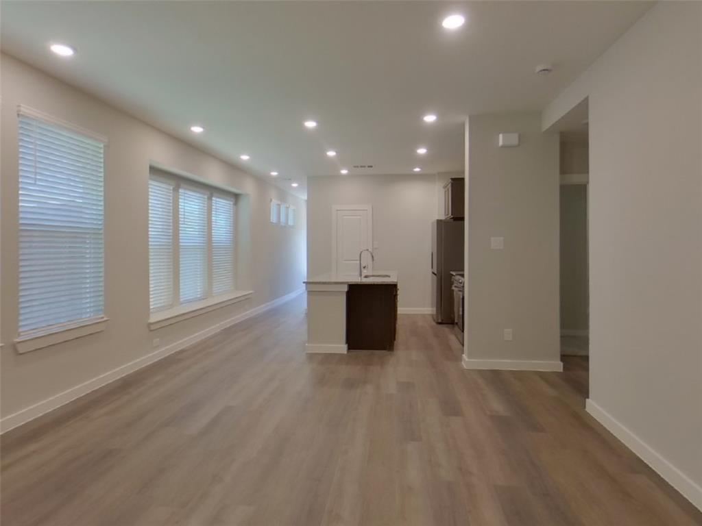 2545 Waddill Rivers Way McKinney, TX 75071 - Photo 4 of 9 a view of a big room with wooden floor and windows