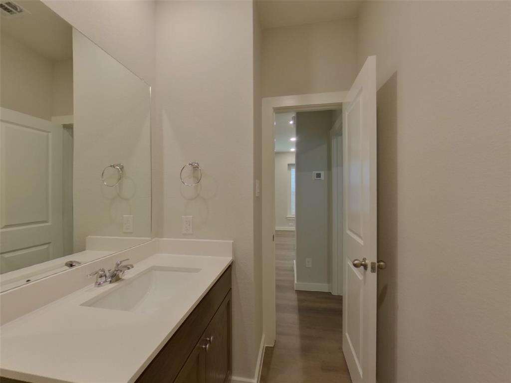 2545 Waddill Rivers Way McKinney, TX 75071 - Photo 5 of 9 a bathroom with a sink and a mirror