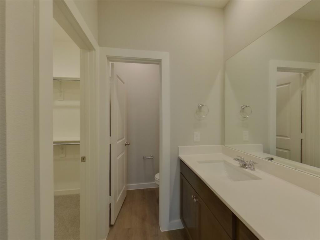 2545 Waddill Rivers Way McKinney, TX 75071 - Photo 8 of 9 a bathroom with a sink and a mirror