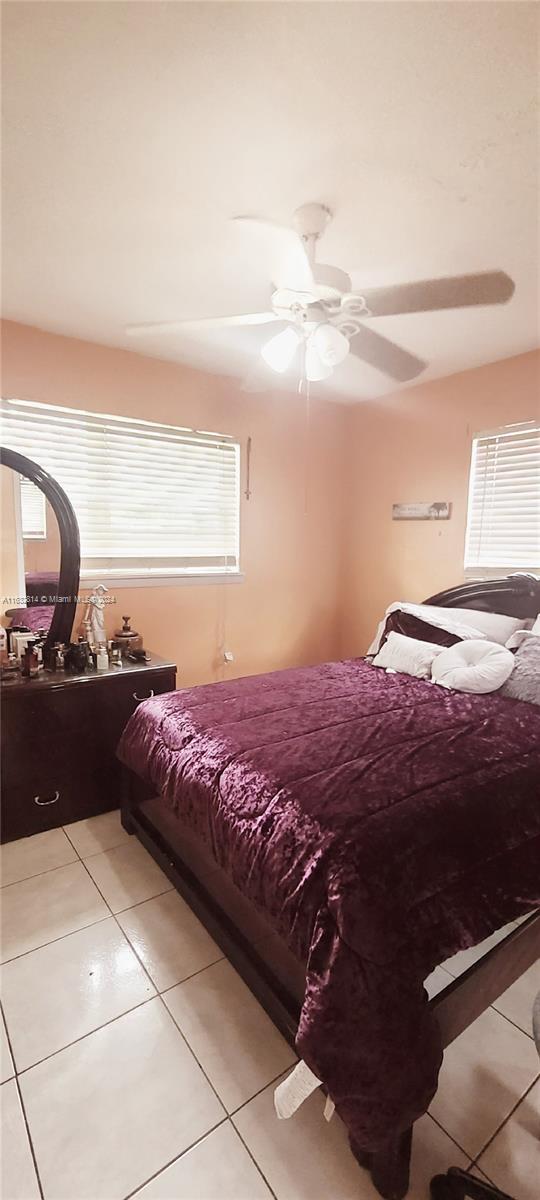 125 Northeast 193rd Street Miami, FL 33179 - Photo 11 of 20 a bed sitting in a bedroom next to a window