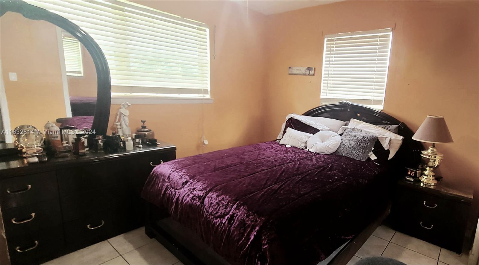 125 Northeast 193rd Street Miami, FL 33179 - Photo 12 of 20 a bedroom with a bed and window