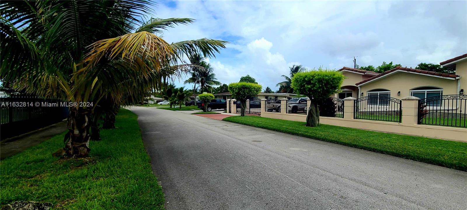 125 Northeast 193rd Street Miami, FL 33179 - Photo 17 of 20 a view of multiple houses with a yard and palm trees