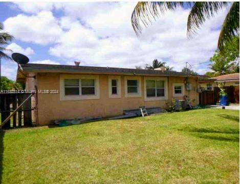 125 Northeast 193rd Street Miami, FL 33179 - Photo 5 of 20 a backyard of a house with table and chairs