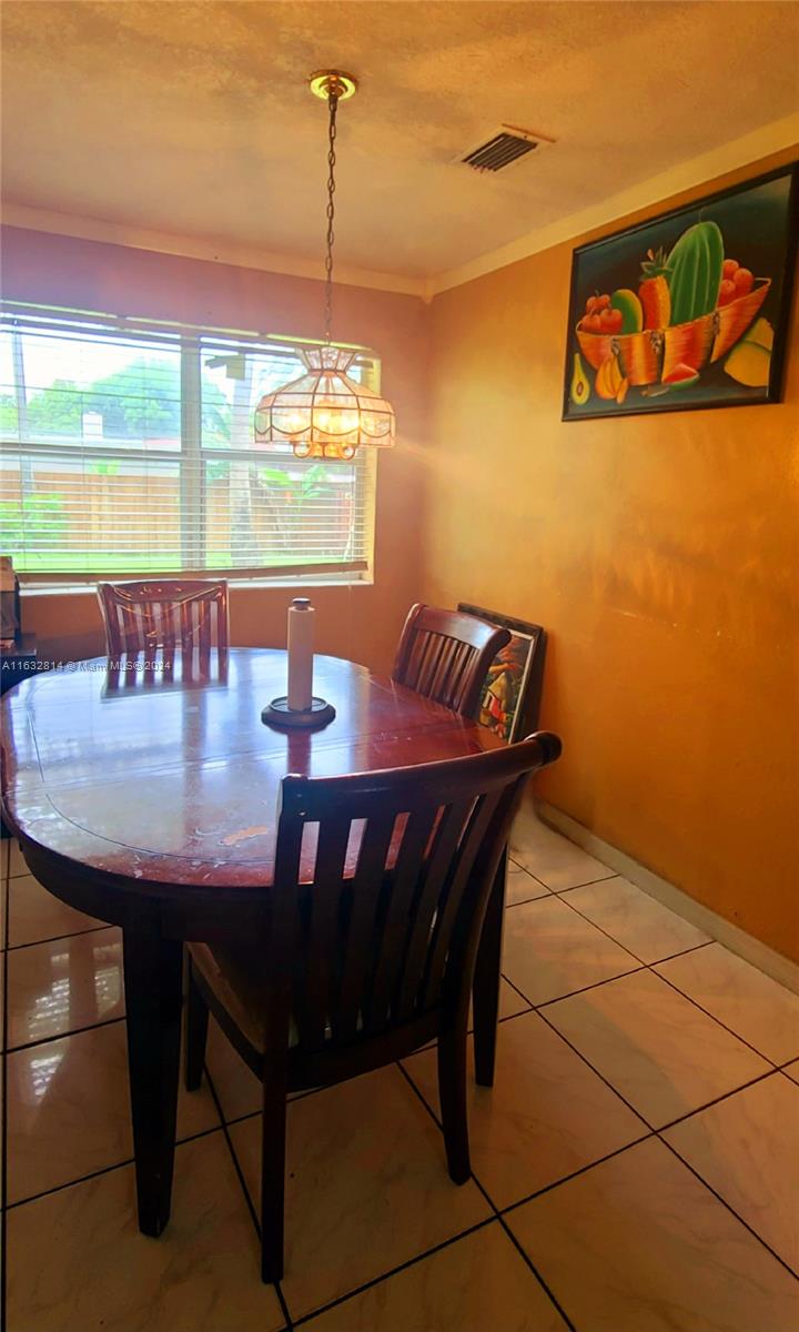 125 Northeast 193rd Street Miami, FL 33179 - Photo 6 of 20 a view of a dining room with furniture and window