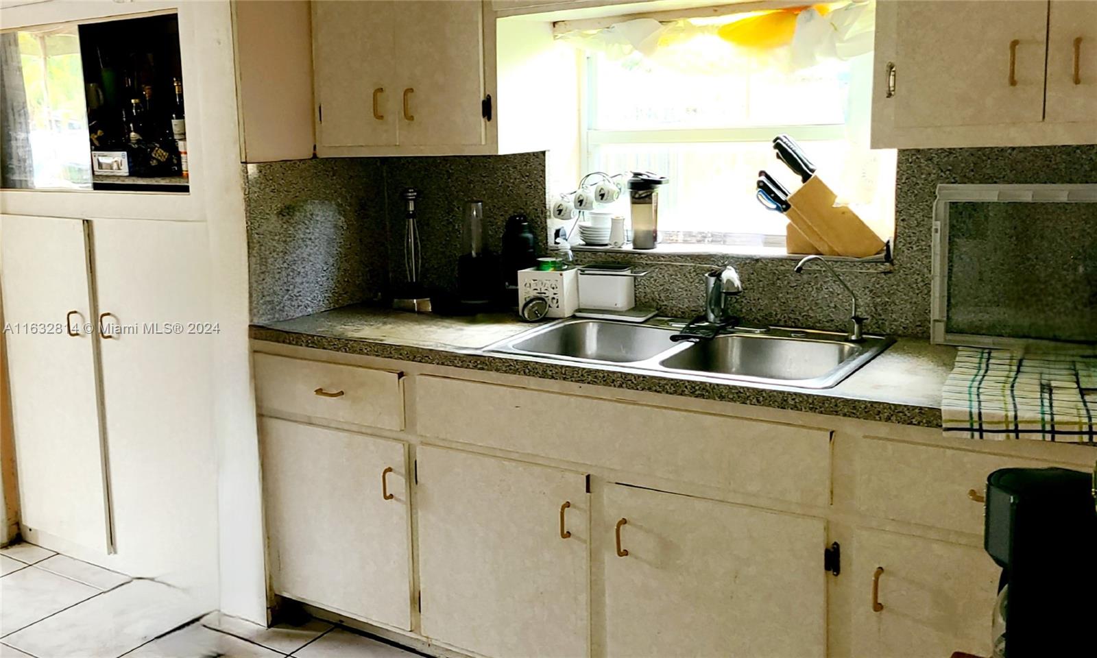 125 Northeast 193rd Street Miami, FL 33179 - Photo 8 of 20 a kitchen with a sink and cabinets