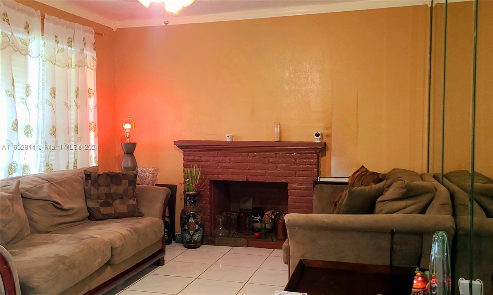 125 Northeast 193rd Street Miami, FL 33179 - Photo 10 of 20 a living room with furniture a fireplace and a large window