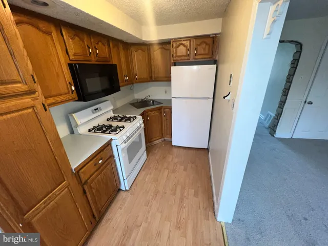 a kitchen with a refrigerator stove and microwave