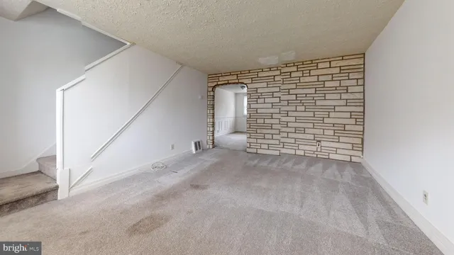 a view of an empty room and garage