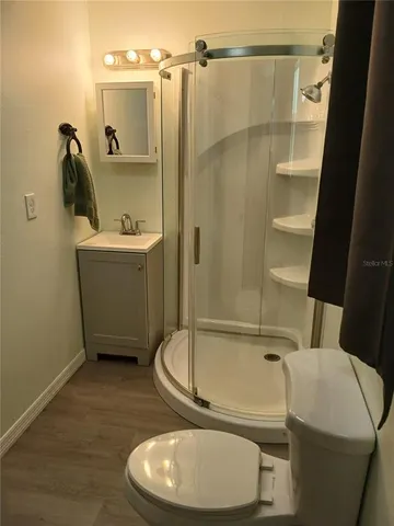 a bathroom with a toilet and a shower