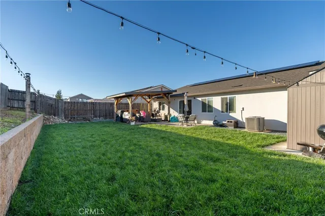 a view of a house with backyard and porch