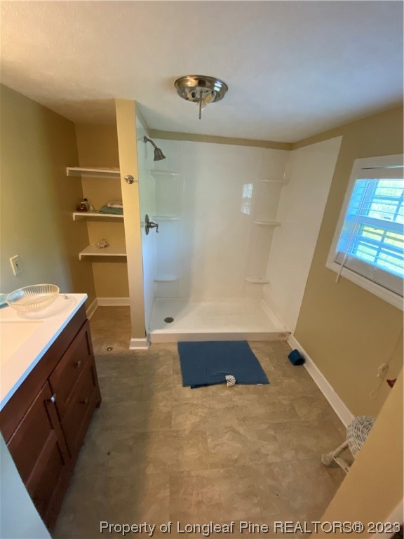 1409 Richardson Road Bladenboro, NC 28320 - Photo 11 of 14 a spacious bathroom with a granite countertop sink a toilet and shower