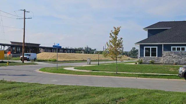a view of a house with a backyard and a tree