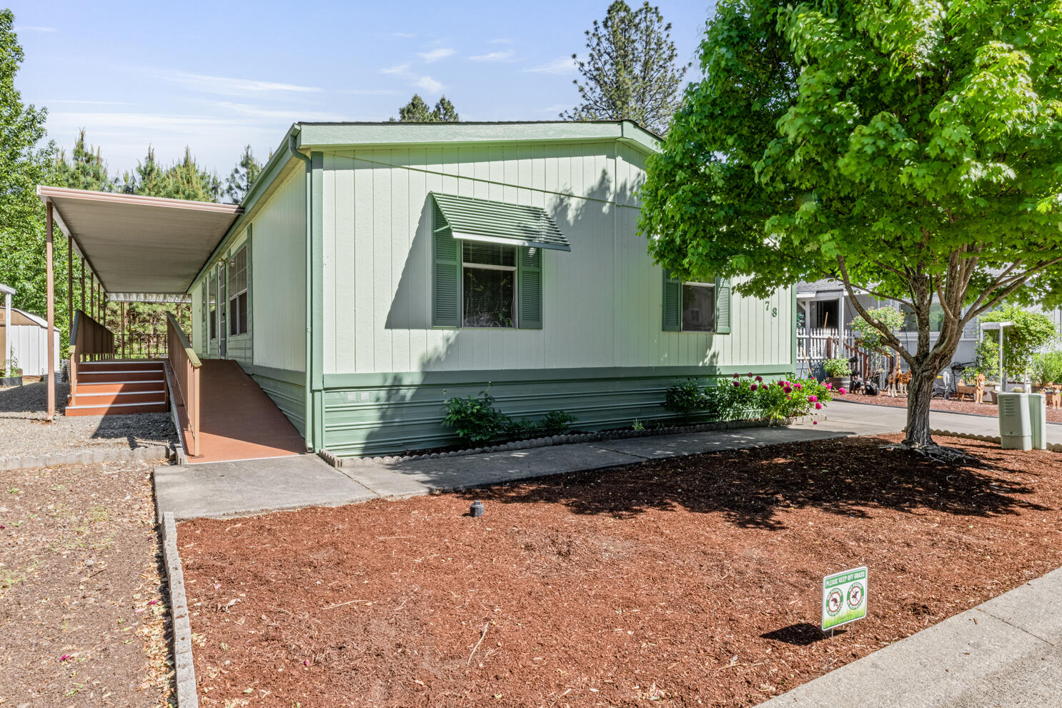 315 West Evans Creek Road, Unit 78 Rogue River, OR 97537 - Photo 1 of 27 a view of a small house with potted plants in front of it