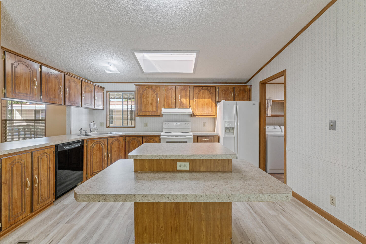 315 West Evans Creek Road, Unit 78 Rogue River, OR 97537 - Photo 14 of 27 a large kitchen with stainless steel appliances wooden floor and a large window