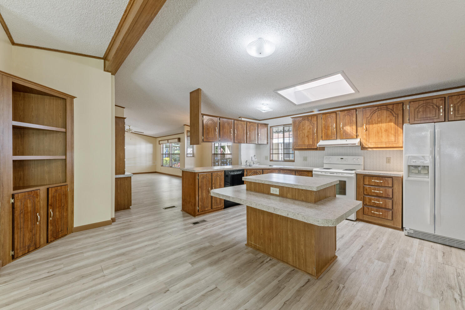 315 West Evans Creek Road, Unit 78 Rogue River, OR 97537 - Photo 15 of 27 a kitchen with wooden floors and wooden cabinets