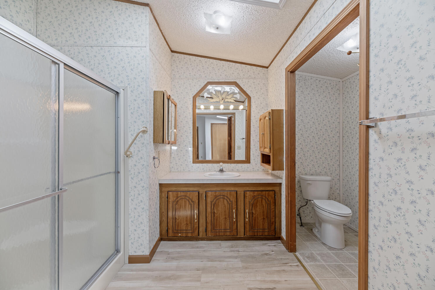 315 West Evans Creek Road, Unit 78 Rogue River, OR 97537 - Photo 19 of 27 a view of bathroom with a toilet sink and a mirror