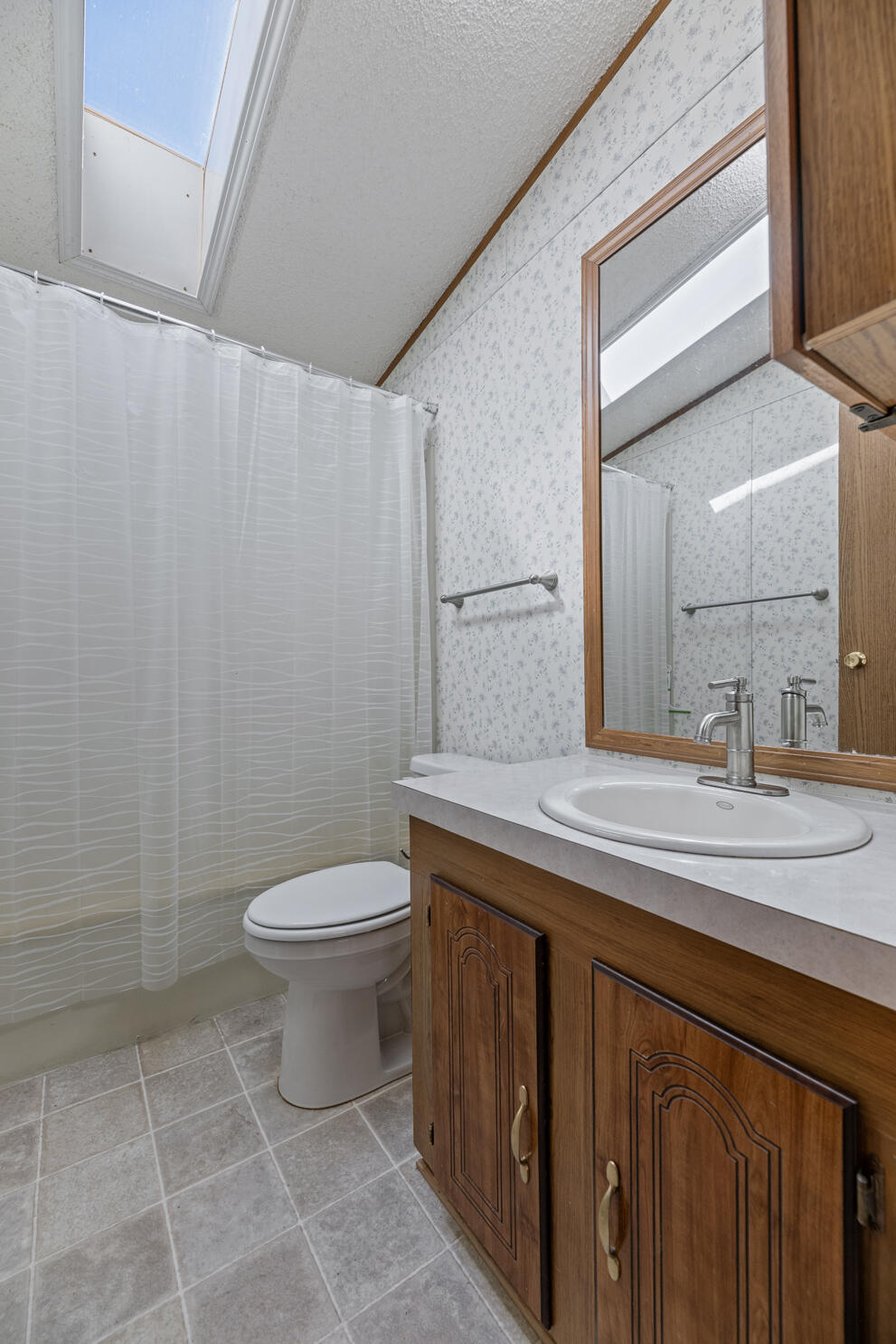 315 West Evans Creek Road, Unit 78 Rogue River, OR 97537 - Photo 20 of 27 a bathroom with a sink a toilet and a mirror