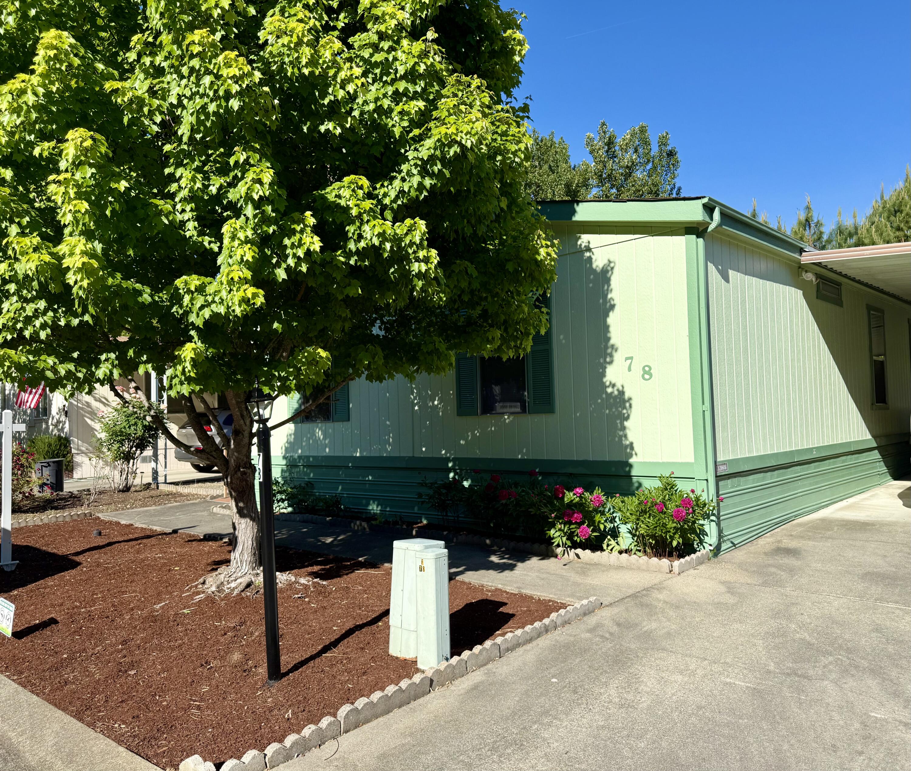 315 West Evans Creek Road, Unit 78 Rogue River, OR 97537 - Photo 2 of 27 a front view of a house with a yard