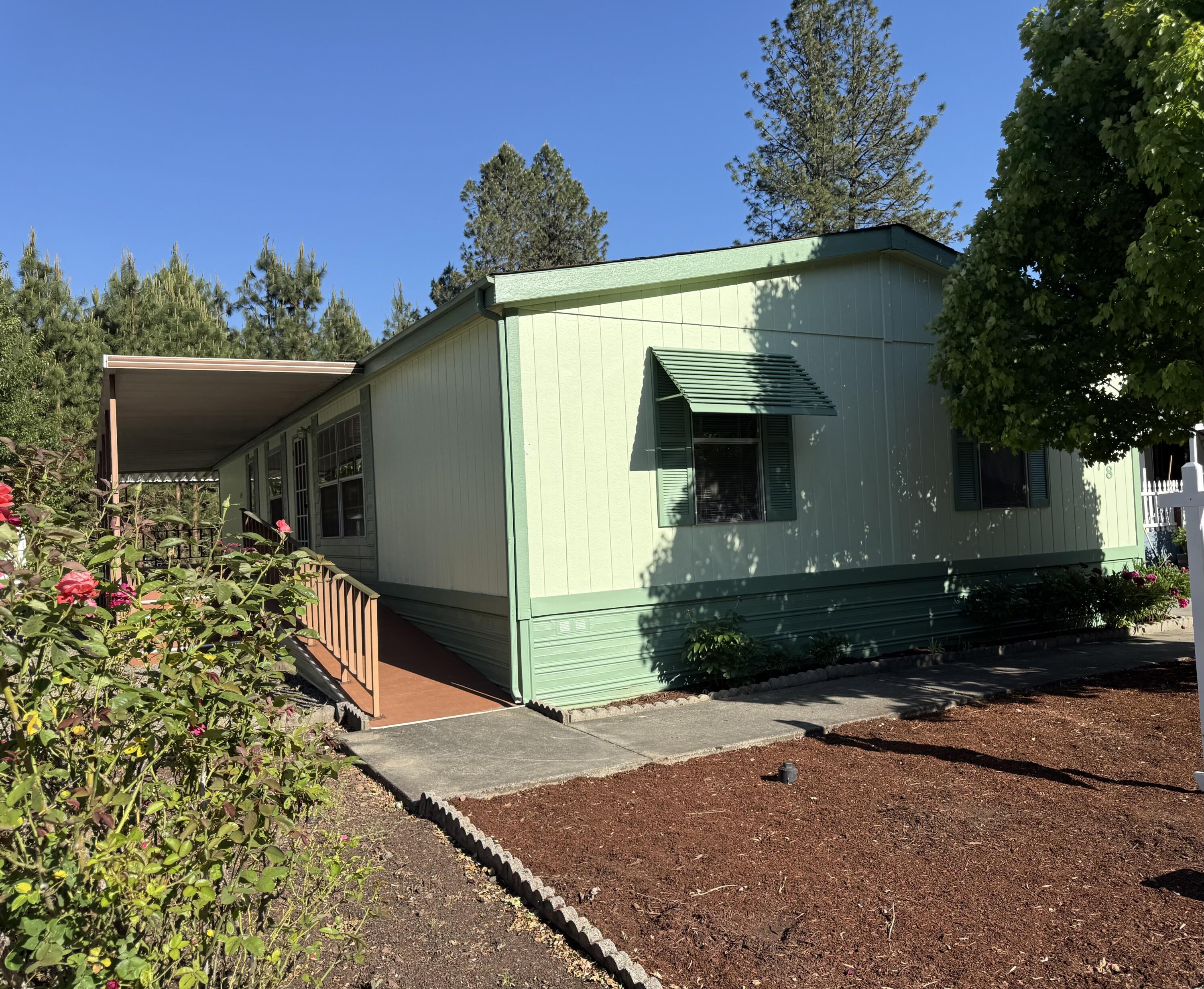 315 West Evans Creek Road, Unit 78 Rogue River, OR 97537 - Photo 3 of 27 a front view of a house with a yard and garage