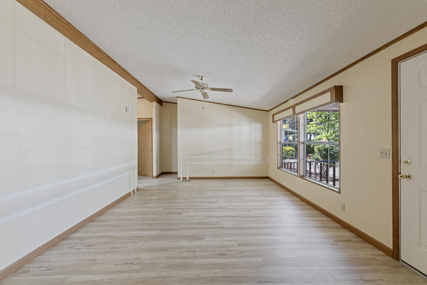 315 West Evans Creek Road, Unit 78 Rogue River, OR 97537 - Photo 8 of 27 a view of an empty room with wooden floor and a window