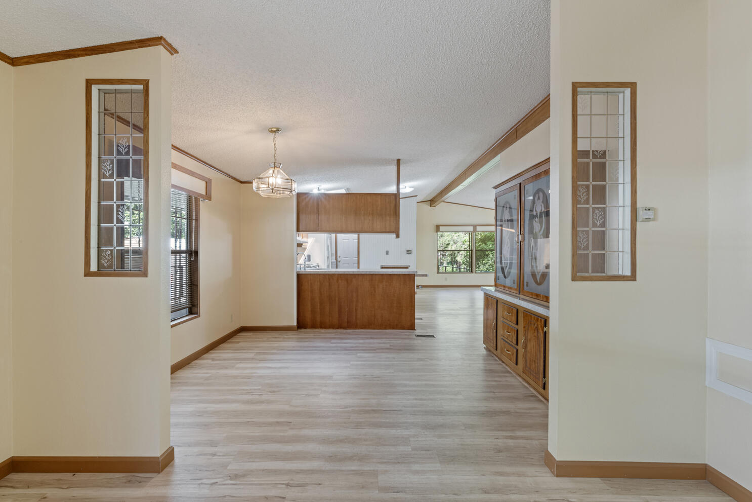315 West Evans Creek Road, Unit 78 Rogue River, OR 97537 - Photo 9 of 27 a view of a kitchen with wooden floor and a window