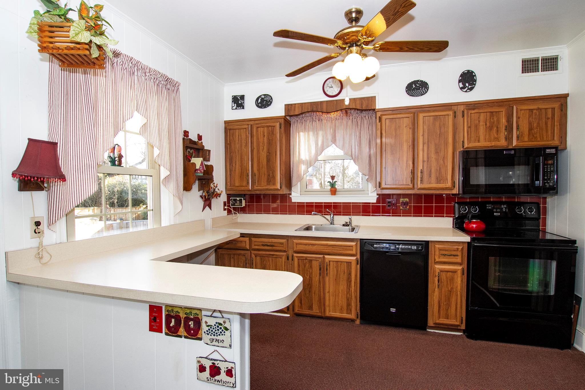 7103 Sheffield Road Baltimore, MD 21212 - Photo 12 of 37 a kitchen with a sink a stove and a window