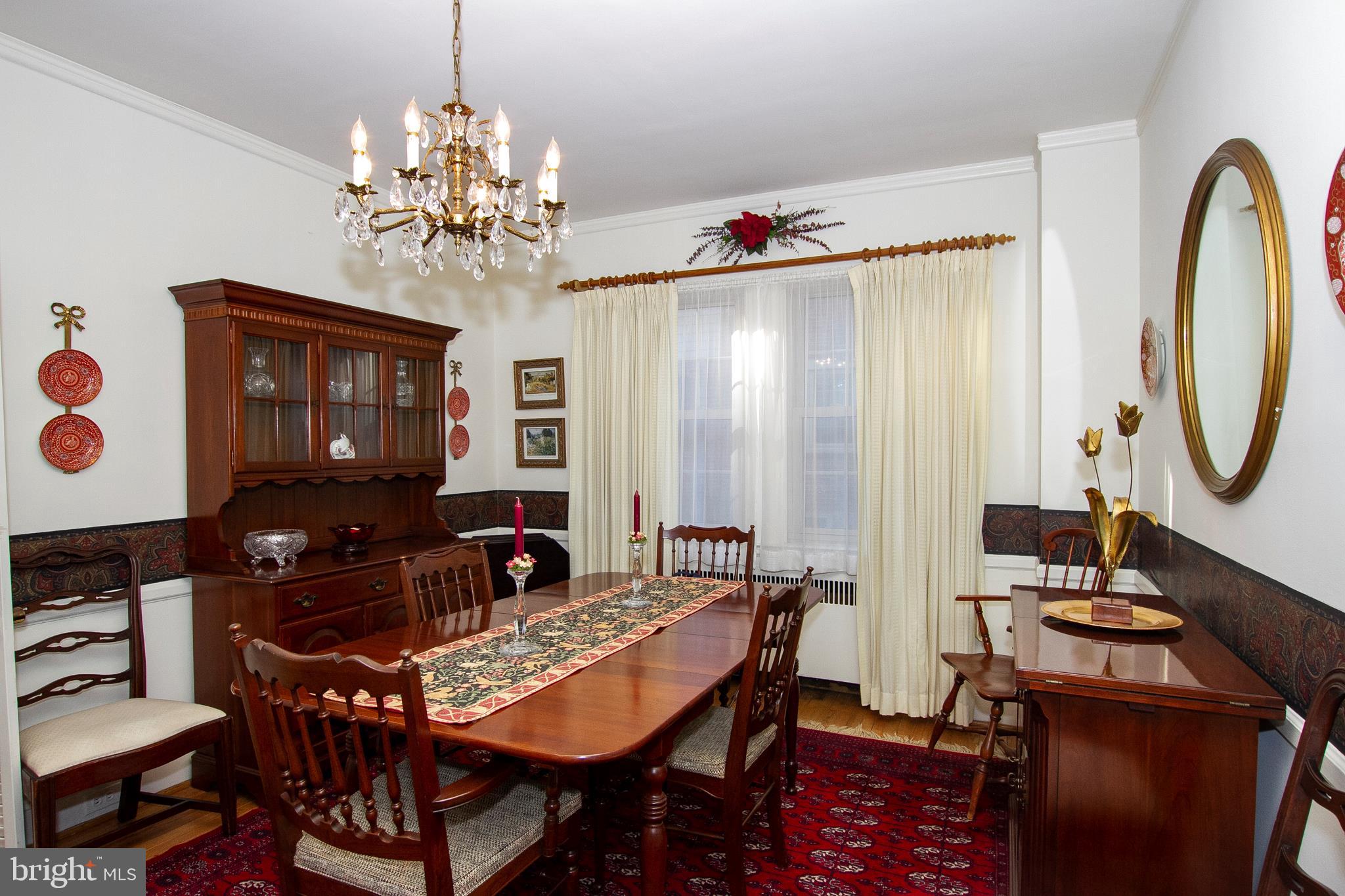 7103 Sheffield Road Baltimore, MD 21212 - Photo 15 of 37 a view of a dining room with furniture and chandelier