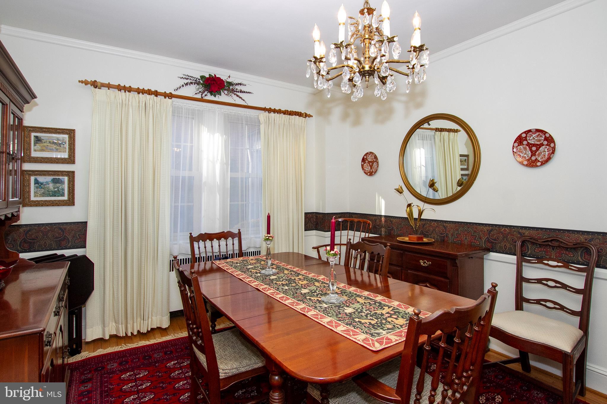 7103 Sheffield Road Baltimore, MD 21212 - Photo 16 of 37 a view of a dining room with furniture and chandelier