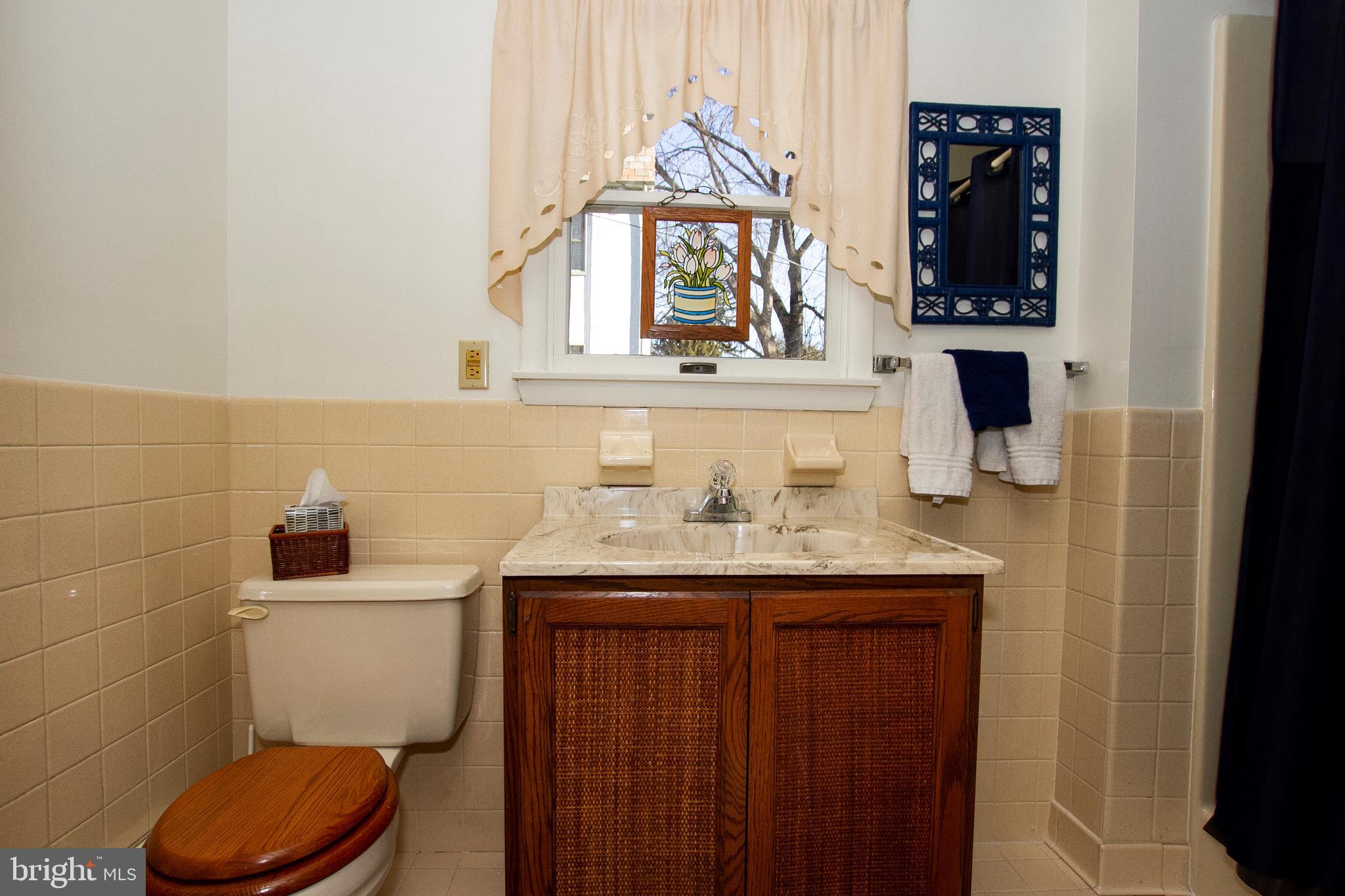 7103 Sheffield Road Baltimore, MD 21212 - Photo 19 of 37 a bathroom with a toilet a sink and mirror