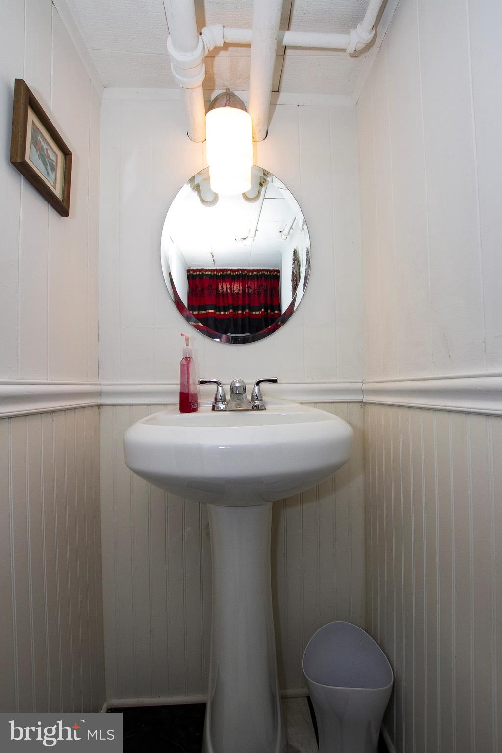 7103 Sheffield Road Baltimore, MD 21212 - Photo 22 of 37 a bathroom with a sink and a mirror