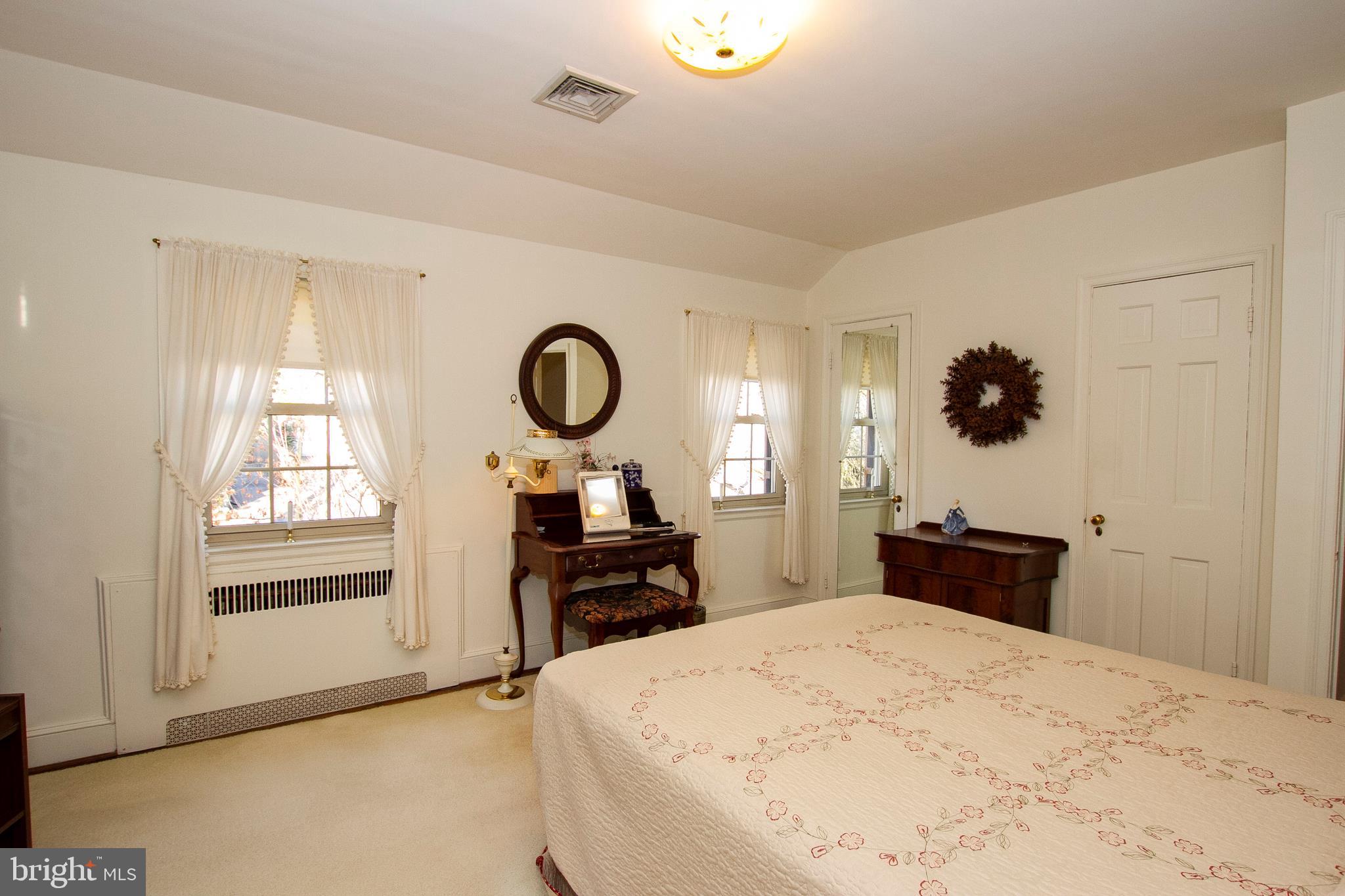 7103 Sheffield Road Baltimore, MD 21212 - Photo 26 of 37 a bedroom with a bed and wooden floor