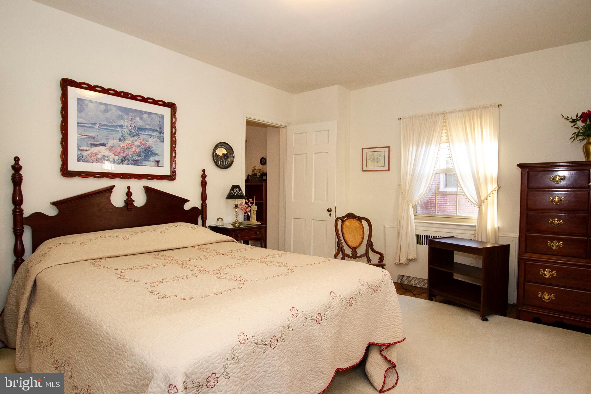 7103 Sheffield Road Baltimore, MD 21212 - Photo 28 of 37 a bedroom with a bed and dresser with mirror