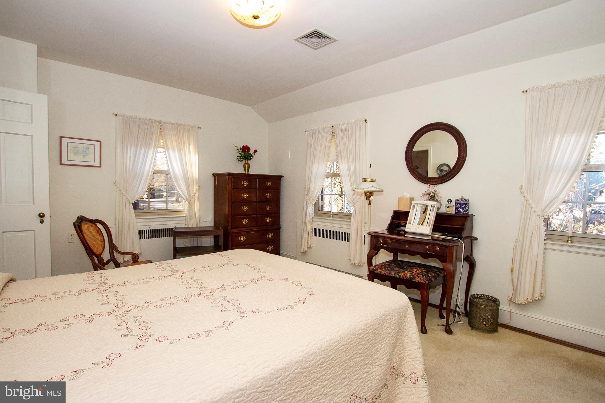 7103 Sheffield Road Baltimore, MD 21212 - Photo 29 of 37 a bedroom with a bed and a dresser