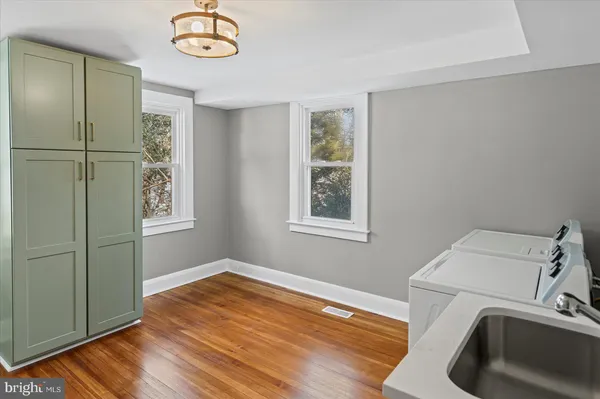 a bedroom with a bed and painting on the wall