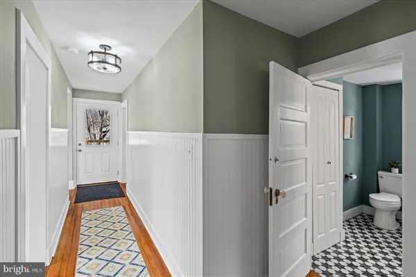 a kitchen with stainless steel appliances granite countertop a table chairs sink and cabinets