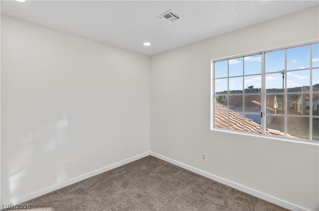 3156 Terrace View Drive Laughlin, NV 89029 - Photo 45 of 94 An inviting room features a wide window and soft carpeting, creating a tranquil atmosphere.
