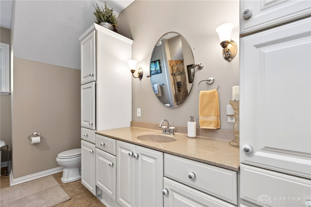 330 South Alpha Bellbrook Road Bellbrook, OH 45305 - Photo 41 of 87 This bright bathroom features a spacious vanity, sleek cabinetry, and warm lighting.