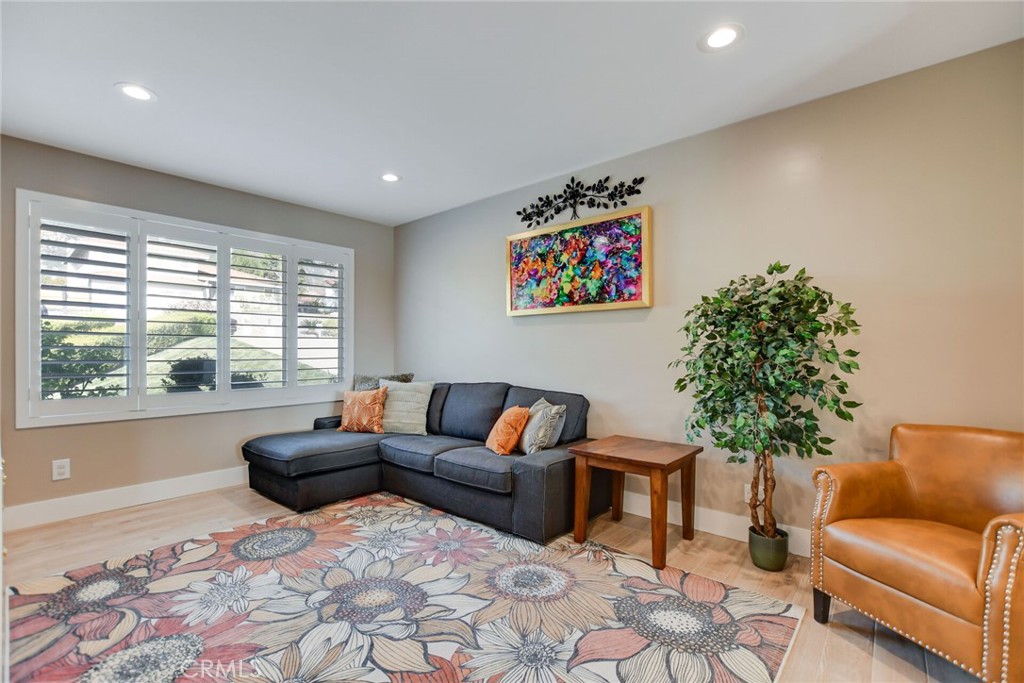 8317 La Senda Road Rancho Cucamonga, CA 91701 - Photo 16 of 75 a living room with furniture and a large tree with wooden floor
