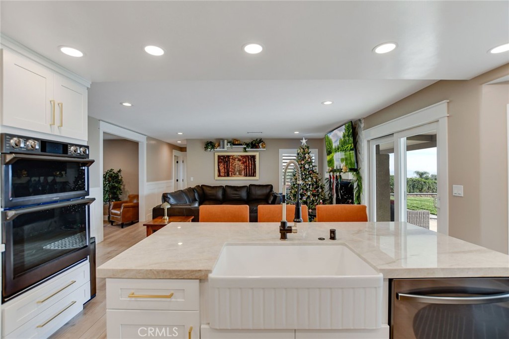 8317 La Senda Road Rancho Cucamonga, CA 91701 - Photo 20 of 75 a kitchen with a refrigerator a stove and a sink with wooden floor
