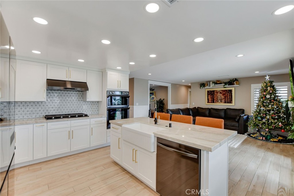 8317 La Senda Road Rancho Cucamonga, CA 91701 - Photo 27 of 75 a kitchen with stainless steel appliances granite countertop a sink stove and refrigerator