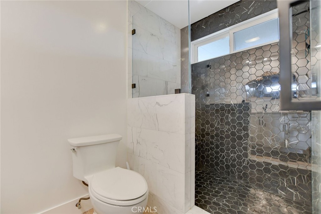 8317 La Senda Road Rancho Cucamonga, CA 91701 - Photo 35 of 75 a white toilet sitting next to a bathroom sink