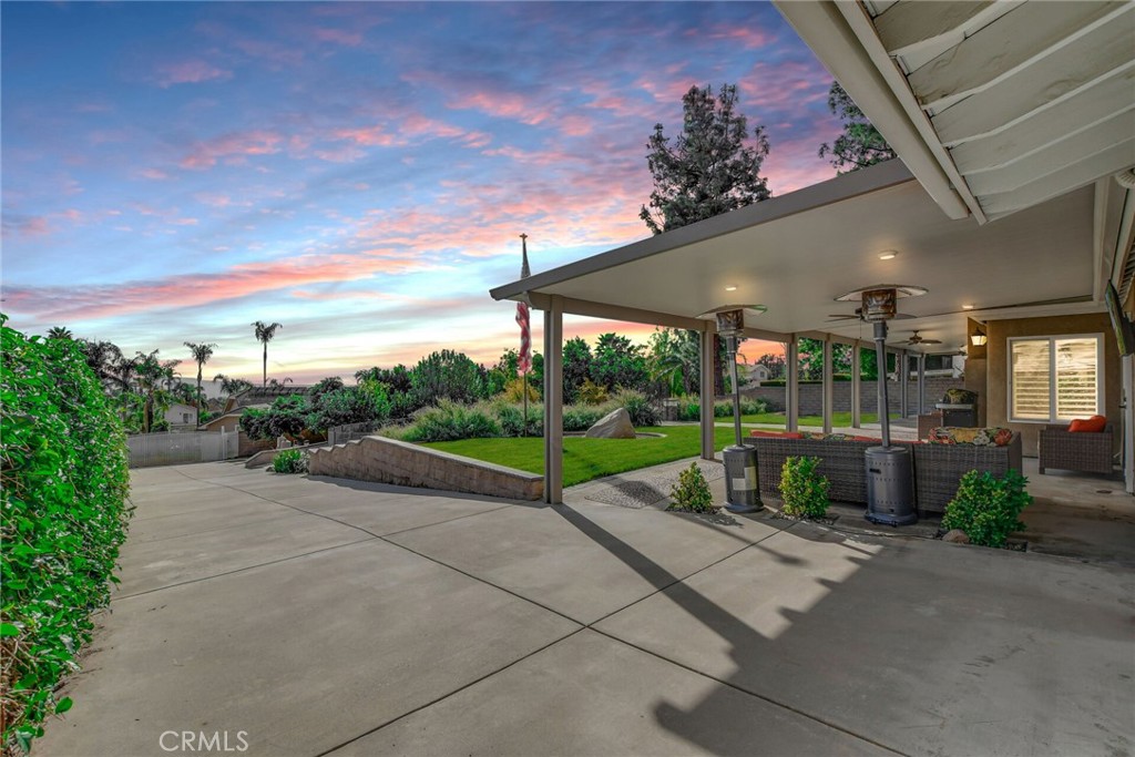 8317 La Senda Road Rancho Cucamonga, CA 91701 - Photo 43 of 75 a view of a patio with a table and chairs under an umbrella