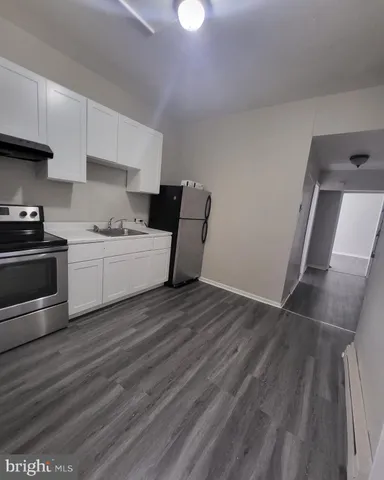 a room with a sink and a stove top oven