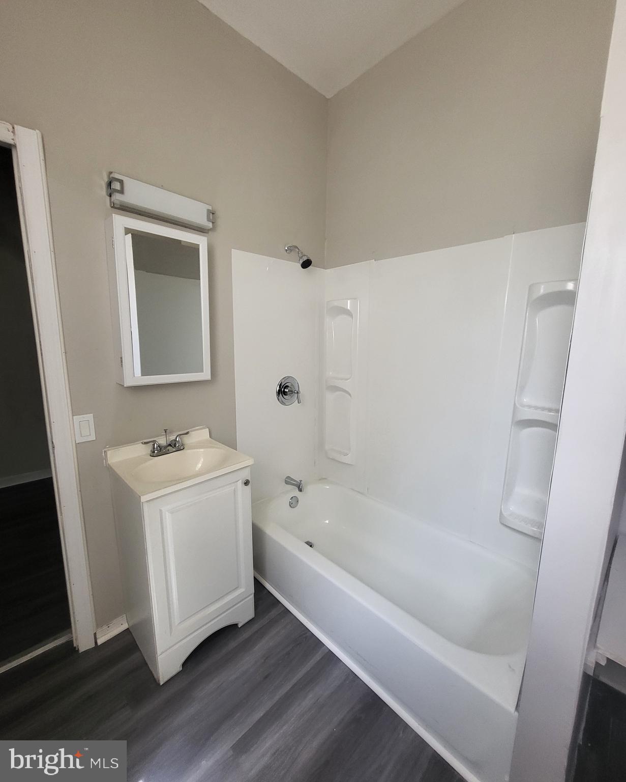 3948 North 5th Street Philadelphia, PA 19140 - Photo 6 of 7 a bathroom with a bathtub sink and mirror