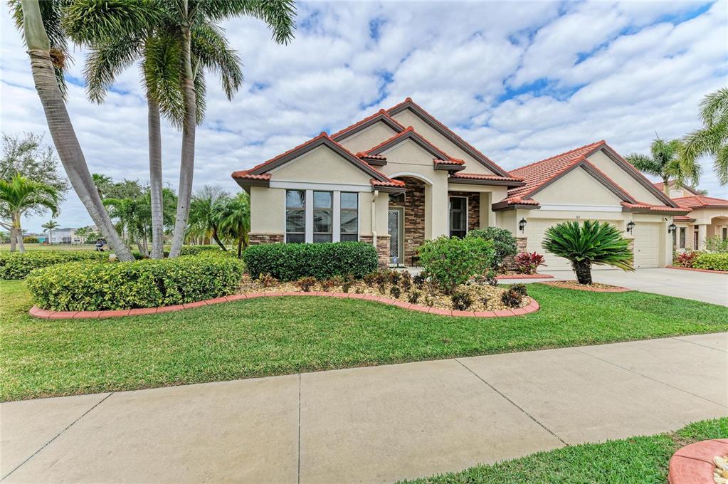 302 Cockle Shell Loop Apollo Beach, FL 33572 - Photo 48 of 75 a front view of a house with a yard
