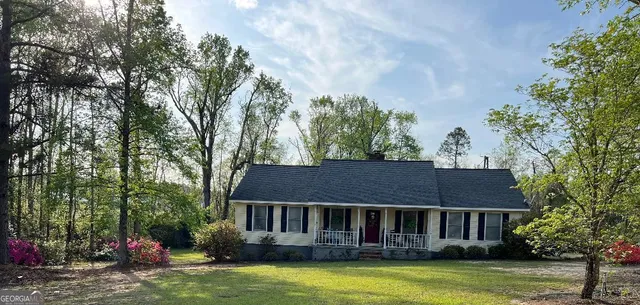 a view of a house with swimming pool and sitting area
