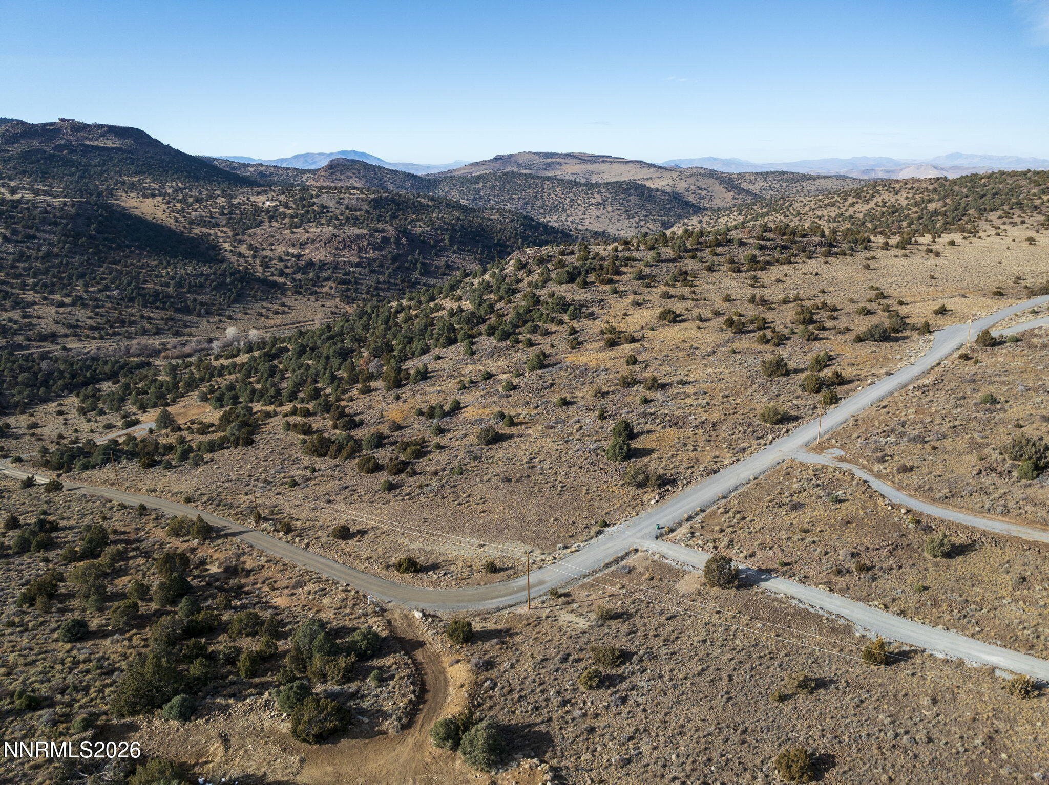 2690 Goldfield Road, Unit PARCEL IS BORDERED BY GOLDFIELD ON SOUTH AND EAST Reno, NV 89521 - Photo 18 of 30 a view of a dry field with mountains in the background