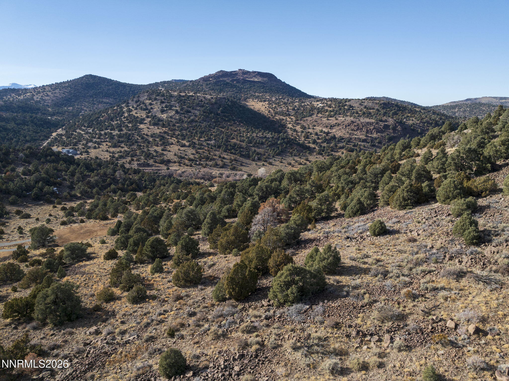 2690 Goldfield Road, Unit PARCEL IS BORDERED BY GOLDFIELD ON SOUTH AND EAST Reno, NV 89521 - Photo 25 of 30 a view of a house with a mountain in the background