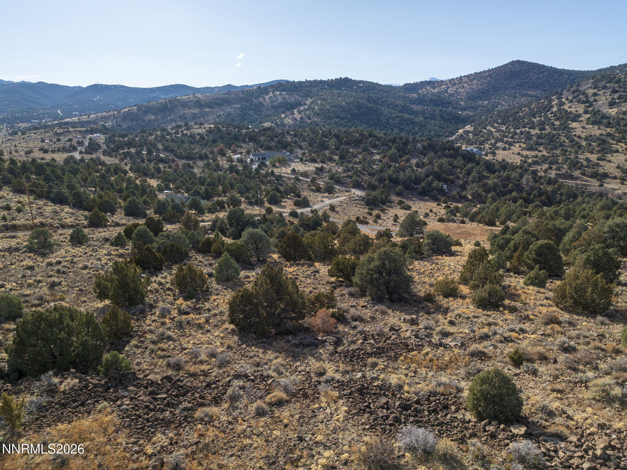 2690 Goldfield Road, Unit PARCEL IS BORDERED BY GOLDFIELD ON SOUTH AND EAST Reno, NV 89521 - Photo 27 of 30 a view of a mountain in the distance in a field