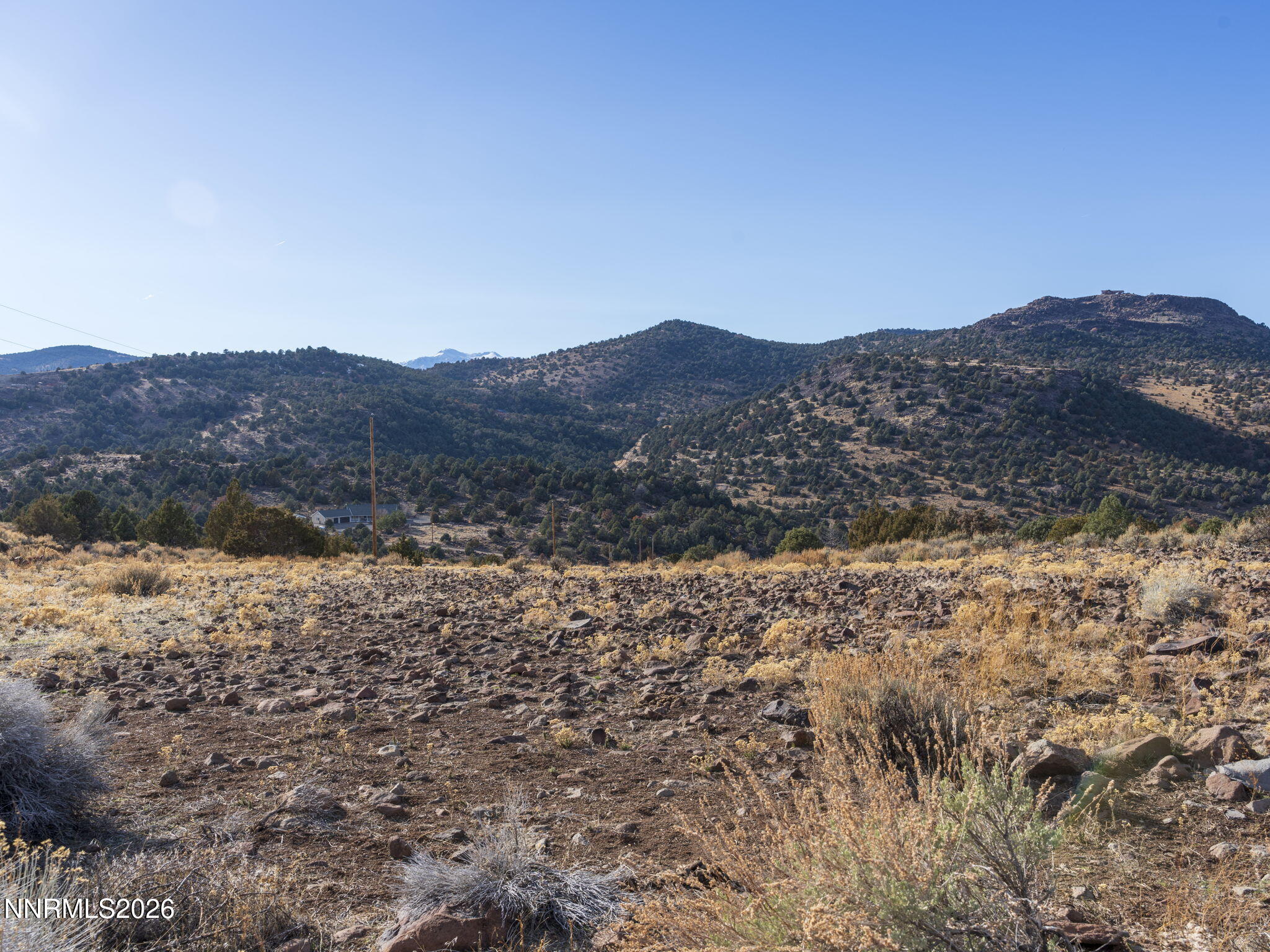 2690 Goldfield Road, Unit PARCEL IS BORDERED BY GOLDFIELD ON SOUTH AND EAST Reno, NV 89521 - Photo 8 of 30 a view of a dry yard with mountains in the background